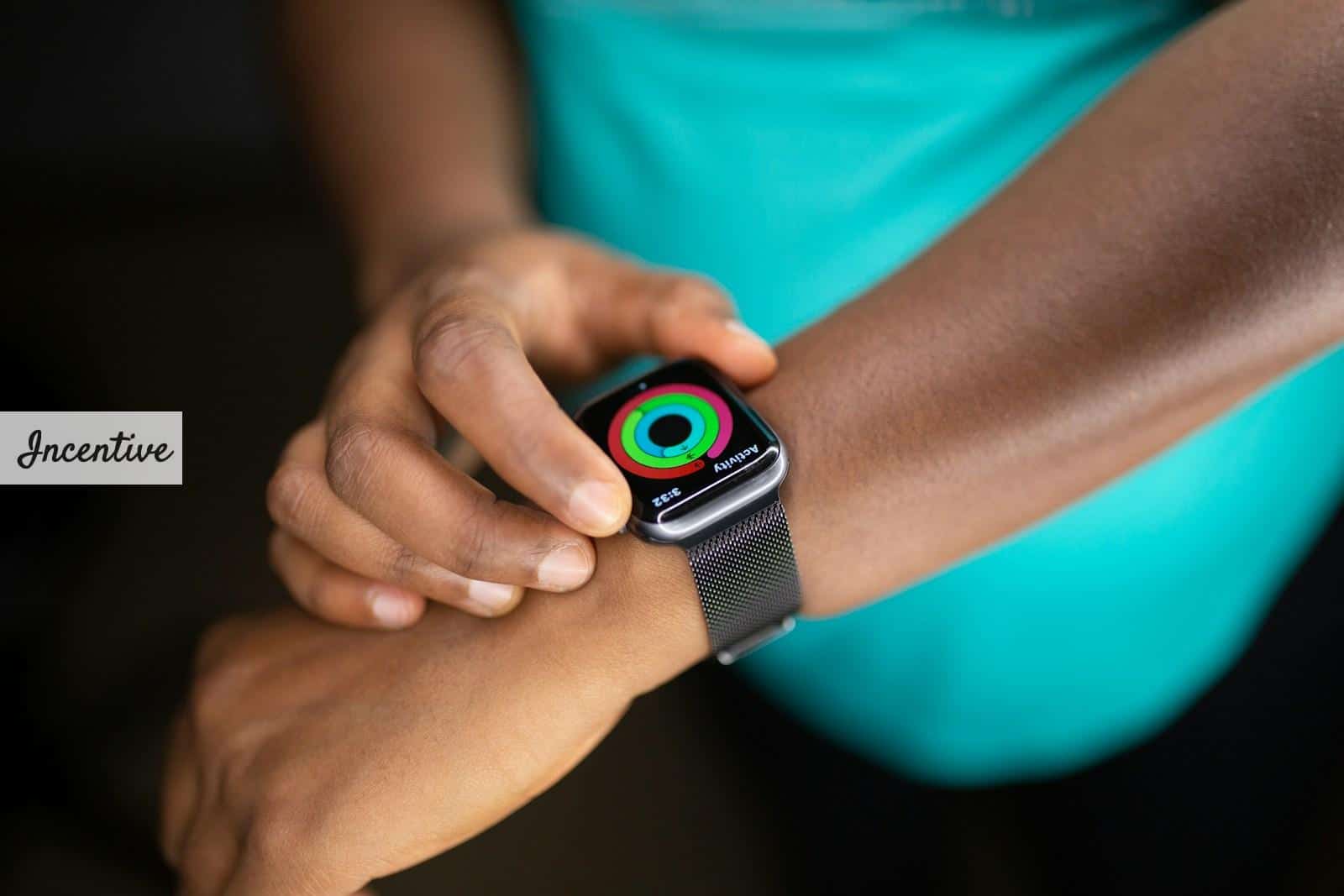 person wearing silver aluminum case apple watch with white sport band